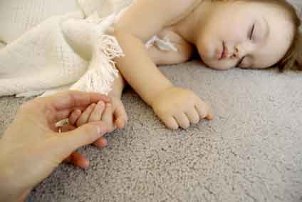 baby sleeping on carpet